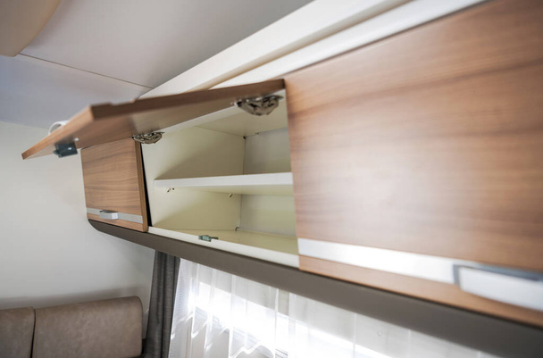 Elegant Camper Van Overhead Cabinet Storage Area. Modern Motorhome RV Recreational Vehicle Features. - Foto, Imagem