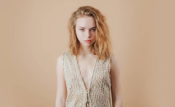 Look at camera. Nude girl knitted vest. Cozy sweater fashion - Фото, изображение