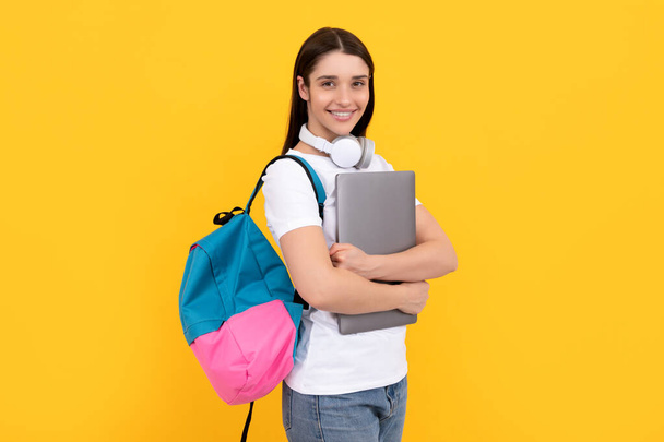 influencer blogging. cheerful girl with backpack and headphones. webinar for modern education. communication technology. woman with school bag hold laptop. buy online. back to school. - Photo, image