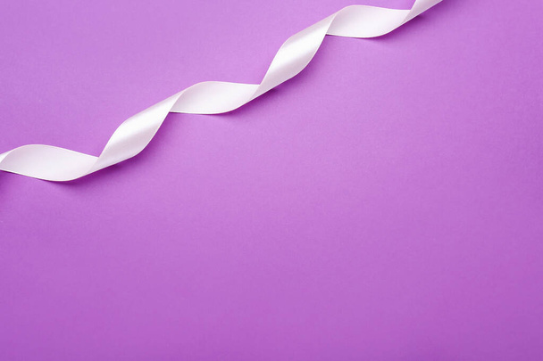Beautiful white ribbon on purple background, top view. Space for text - Photo, Image