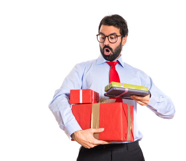 Businessman with gift over white - Foto, imagen