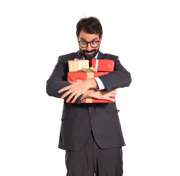 Businessman with several gifts - 写真・画像