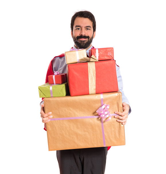 Businessman dressed like superhero holding gifts - Photo, Image