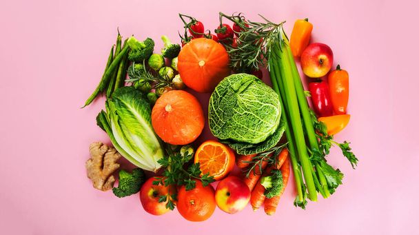 Assortment of vegetables and fruits on colorful background. Detox diet concept. Vegan food. Top view, flat lay, copy space - Foto, afbeelding