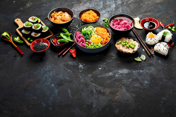 Surtido de comida coreana sobre fondo oscuro. Platos asiáticos y aperitivos de la cocina de hecho. Vista superior, plano, espacio para copiar - Foto, Imagen