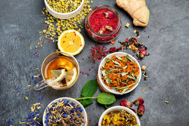 Herbal tea assortment on dark background. Traditional healthcare remedies. Top view, flat lay, copy space - Foto, Imagen