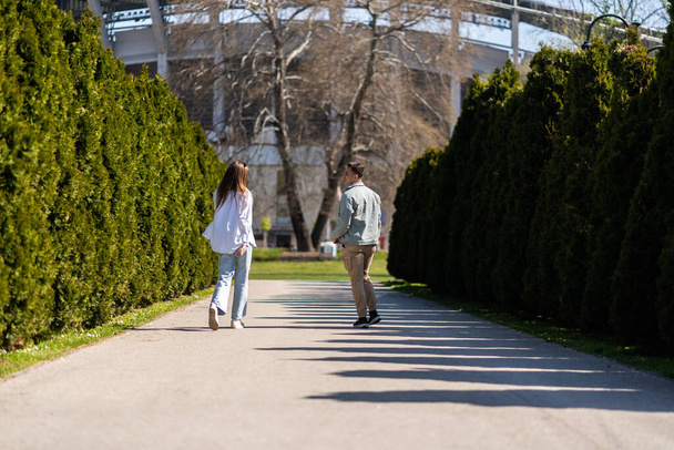 Pár v lásce diskutovat o něčem při procházce v městském parku - Fotografie, Obrázek