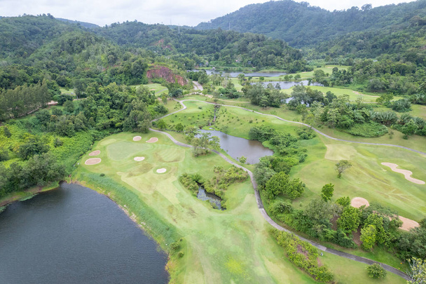 Aerial view drone shot of beautiful green golf field fairway and putting green Top down image for sport háttér és az utazás természet háttér Csodálatos kilátás - Fotó, kép