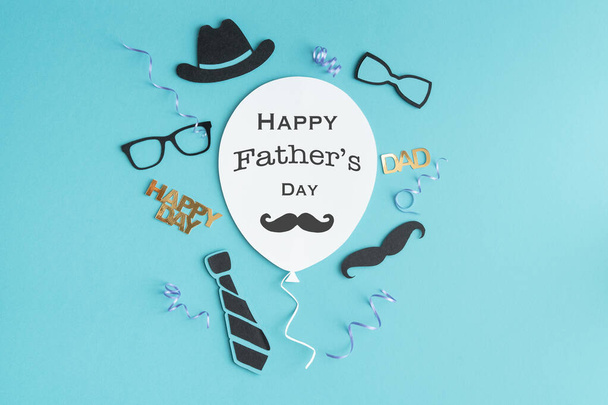 Father's Day greeting balloon card with symbols decoration on paper on blue background. Copy space. - Photo, Image