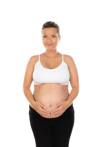 Afbeelding van zwangere vrouw aanraken van haar buik met handen geïsoleerd op een witte achtergrond - Foto, afbeelding