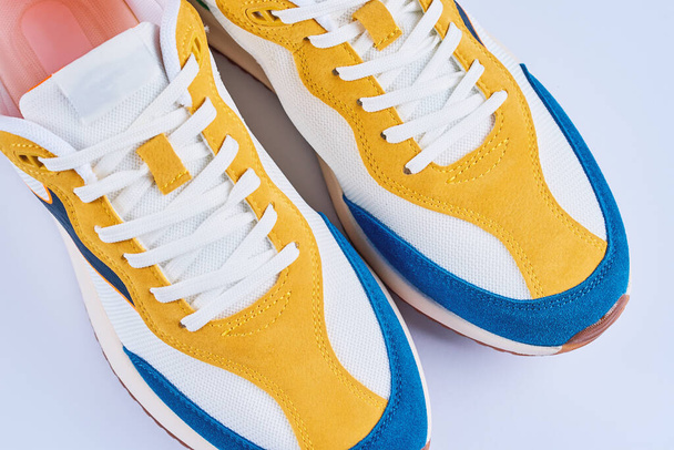 Casual sneakers on yellow background, creative minimalism - Photo, Image