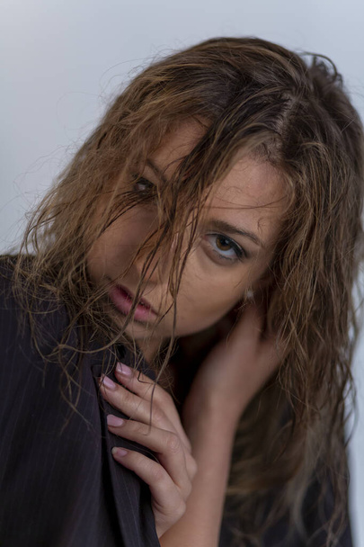 beautiful italian brunette girl posing in studio with wet hair and man's jacket. High quality photo - Fotó, kép