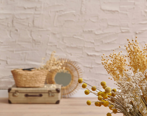 Wicker home object, bag, vase, mirror, baggage, plant in front of the concrete stone wall background, cotton dry plant, hanging, chair, blanket, decoration interior house room. - Photo, Image