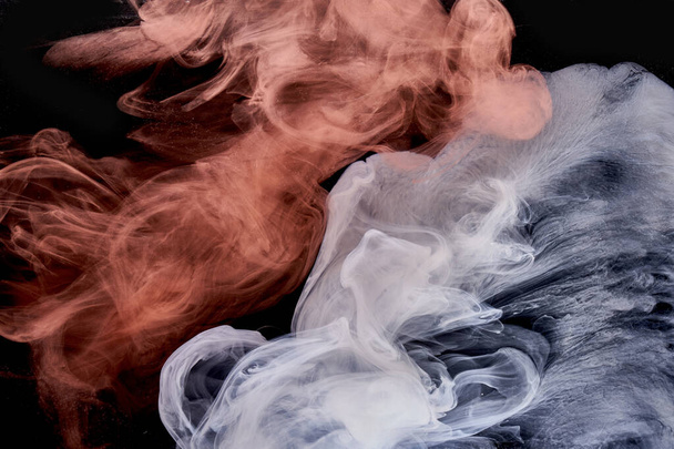 Orange white smoke on black ink background, colorful fog, abstract swirling touch ocean sea, acrylic paint pigment underwater - Фото, зображення