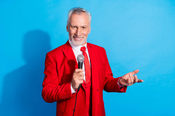 Photo of funny cheerful entertainer man hold microphone beaming smile wear red tux shoes isolated blue color background. - Foto, imagen