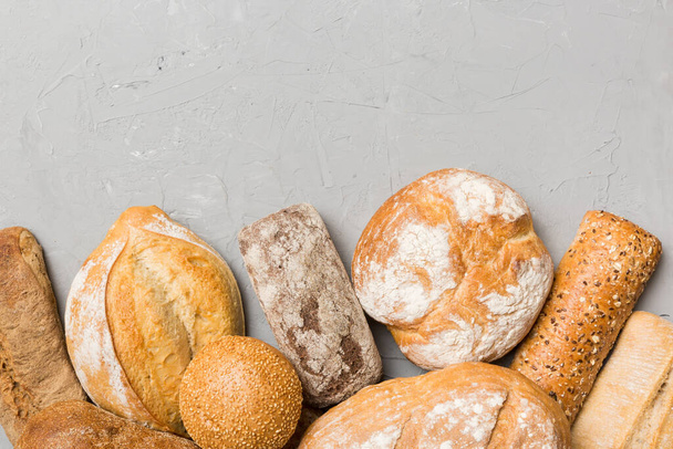 Homemade natural breads. Different kinds of fresh bread as background, top view with copy space. - Photo, image