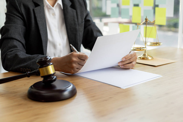 Attorneys are reviewing contract documents for the client, in which the client has filed a lawsuit against an employee at a company that commits the fraud. Fraud litigation concept. - Photo, Image