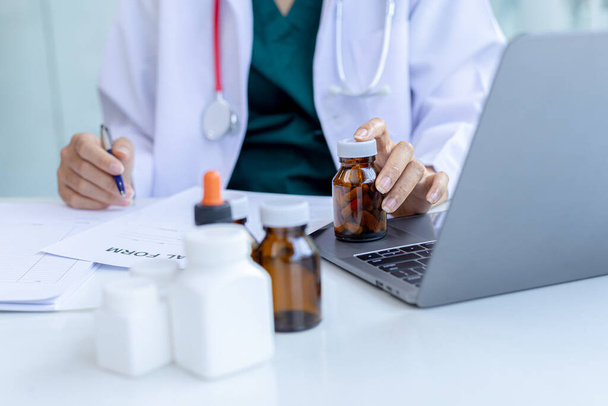 The pharmacist is reviewing the list of drugs and checking the stock of all medicines at one of the pharmacies he owns, his home pharmacy and selling medical supplies. Pharmacy concept. - Photo, Image