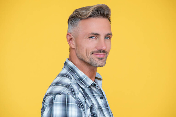glad mature man with grizzle hair on yellow background. - Фото, зображення