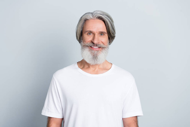 Photo of cheerful handsome man pensioner dressed white t-shirt isolated grey color background. - 写真・画像