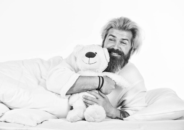 Good vibes. Imaginary friends. I am not alone. Cute teddy bear toy. Lovely hipster. Positive bedroom environment. Playful and romantic. Bearded hipster play toy. Man hug soft toy relaxing in bed. - 写真・画像