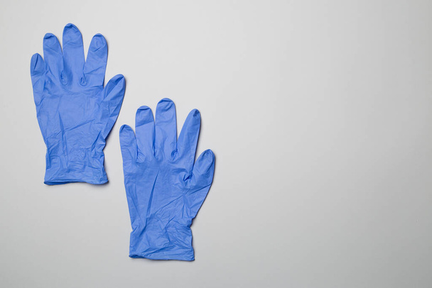 Blue latex gloves on color background. - Photo, Image