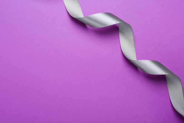 Beautiful silver ribbon on purple background, top view. Space for text - Foto, Imagem