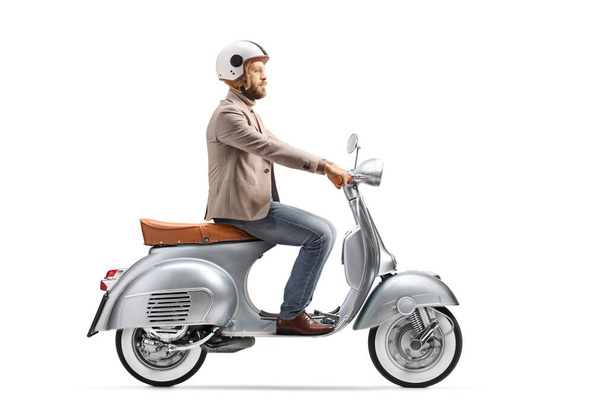 Young man with a helmet riding a vintage scooter isolated on white background - Φωτογραφία, εικόνα