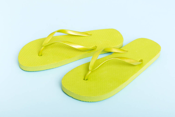Beach accessories. Flip flops and starfish on colored background. Top view Mock up with copy space. - Fotó, kép