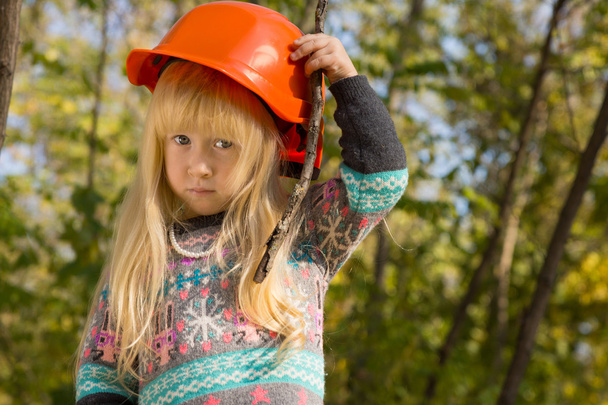 Cute little girl adjusting her hardhat - Фото, изображение