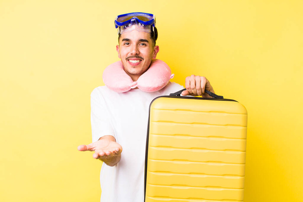 young hispanic man smiling happily with friendly and  offering and showing a concept. travel concept - Фото, зображення