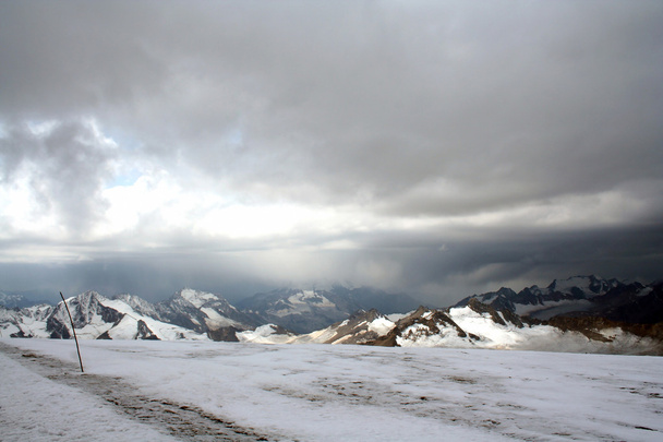 Ice slope of Mount Elbrus against the Big Caucasian spine - Photo, Image