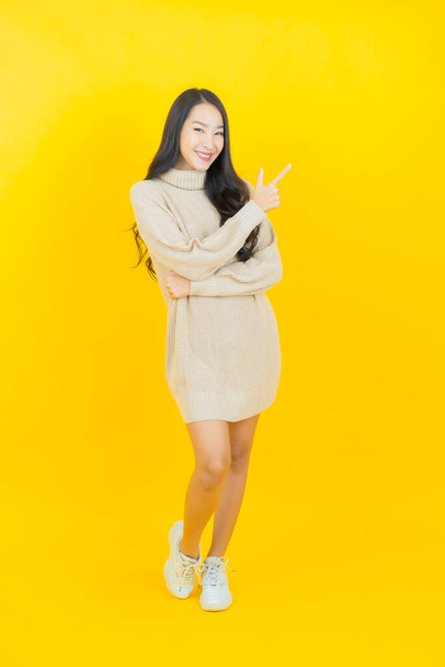 Portrait beautiful young asian woman smile with action on color background - Foto, immagini