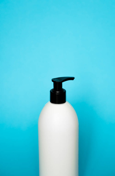 Plastic shampoo bottle on a blue background. Mock up template for design - Фото, изображение