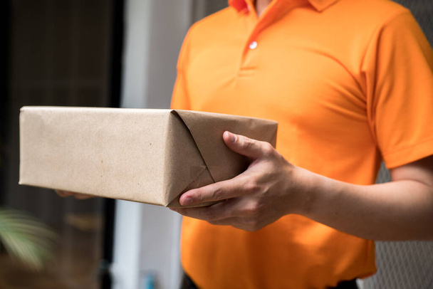 Staff sending parcels in orange uniform. - Фото, изображение
