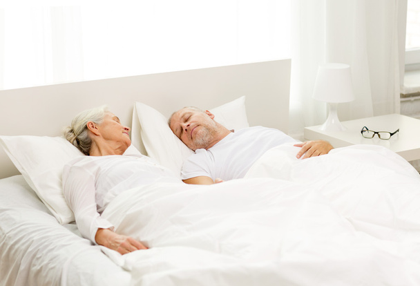 happy senior coupler lying in bad at home - Foto, immagini