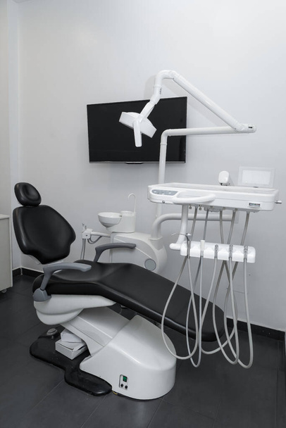stylish and modern interior decoration of dental office with comfortable chair, medical tools and lamp, modern objects without people - Photo, Image