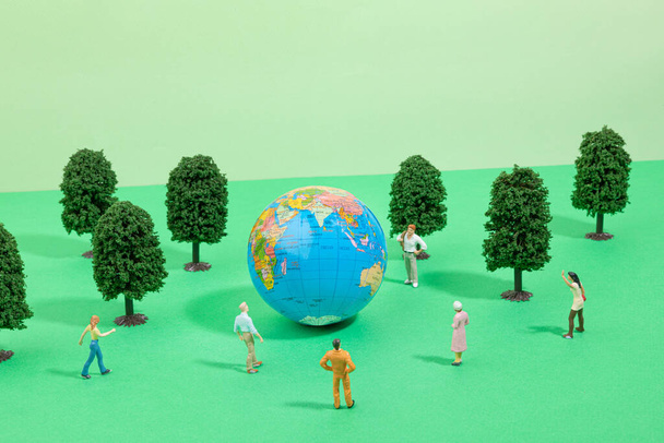 protect earth and environment concept, globe and people, forest miniature - 写真・画像