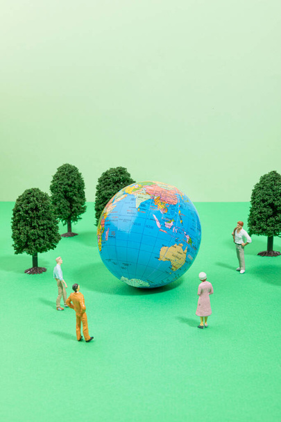 protect earth and environment concept, globe and people, wood miniature - Fotografie, Obrázek
