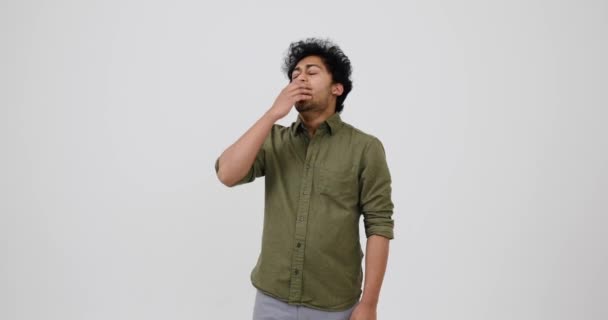 Tired young Indian man yawning over white background - Footage, Video