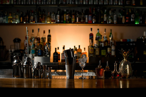 beautiful view of composition with different bar equipment and steel tools which stand on bar counter. Blurred bar background - Foto, imagen