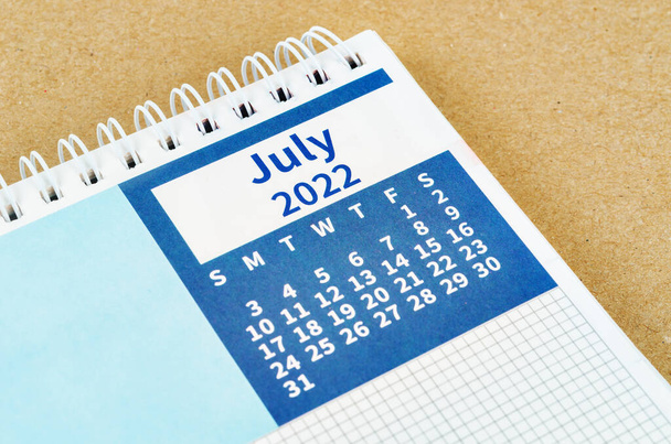 Close up July 2022 desk calendar on wooden background. - Фото, зображення