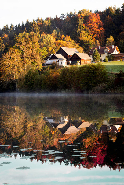 small village on the shore and its reflection in the lake. Austri - Fotó, kép