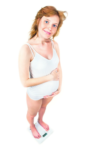 Pregnant woman standing on scales - Zdjęcie, obraz
