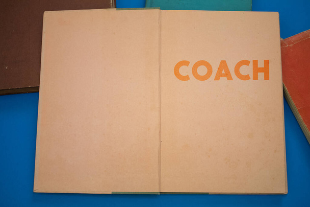 Coach word in opened book with vintage, natural patterns old antique paper design. - Photo, Image