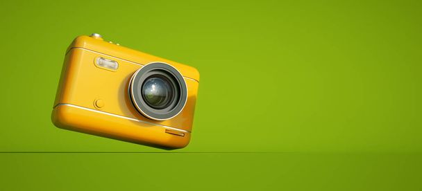 3D рендеринг желтой камеры на зеленом фоне с большим количеством места для копирования - Фото, изображение