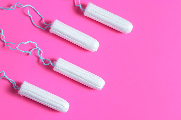 Menstrual period concept. Woman hygiene protection. Cotton tampons on pink background - Fotoğraf, Görsel
