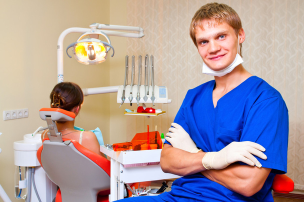 Young dentist in his office looking at the viewer - Fotoğraf, Görsel