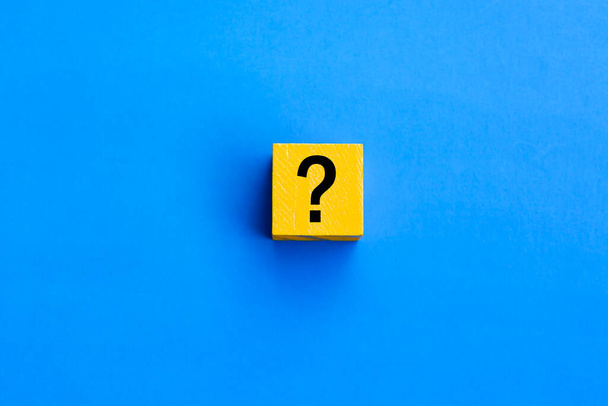 Cube with question mark on blue background. Question and answer concept. - Фото, изображение