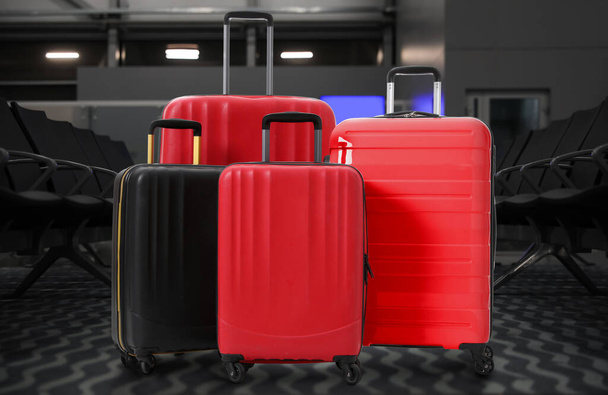 Stylish suitcases in waiting area at airport terminal - Foto, afbeelding